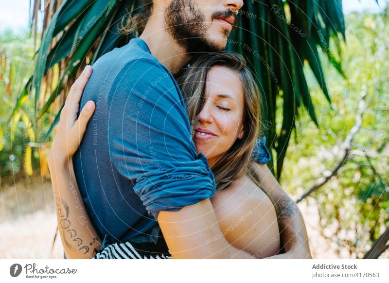 Tender couple hugging in nature romantic gentle face to face touch tender love relationship together park multiracial multiethnic diverse tropical fondness