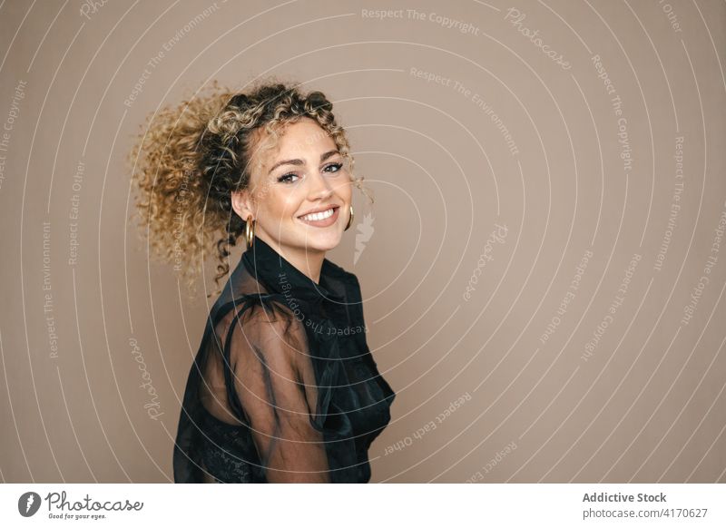 Positive woman smiling in studio having fun candid sincere positive style curly hair afro female hairstyle cheerful happy glad carefree relax joy delight