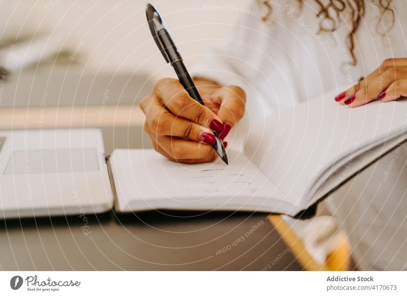 Busy woman making notes in planner write notebook busy take note entrepreneur occupation laptop business female businesswoman freelance organizer work pen
