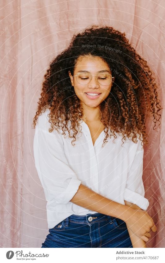 Cheerful black woman smiling with closed eyes eyes closed smile cheerful afro hairstyle charming youth casual female ethnic african american outfit curly hair