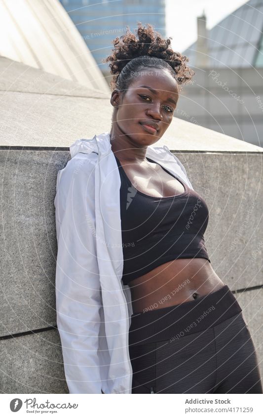 Determined slim black female athlete on street in city fit sportswoman sportswear determine urban sporty healthy ethnic african american lean workout fitness