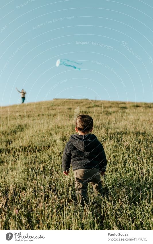 Rear view child looking at Kite Child 1 - 3 years Playing Boy (child) Infancy Human being Toddler Colour photo Joy Happiness Leisure and hobbies Nature Life