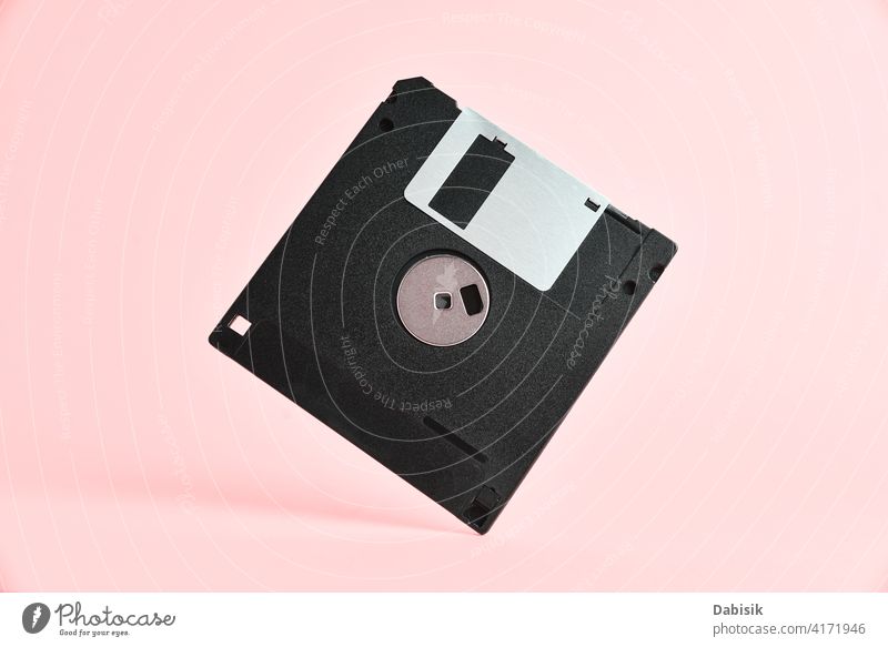 Floppy disk on pink background diskette floppy retro storage computer design abstract vintage office technology data information memory magnetic business black