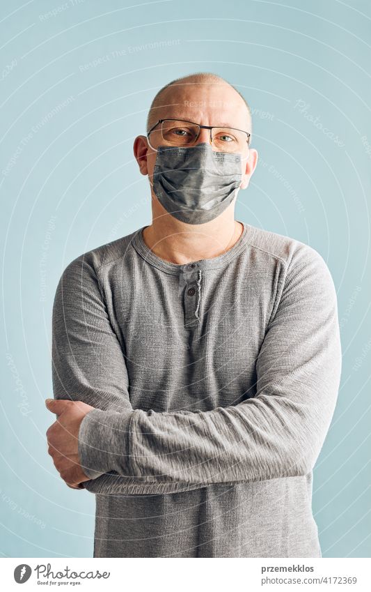 Man patient with face mask. Wearing coronavirus covid-19 protection medical mask during the pandemic person male disease health care hygiene copy space man