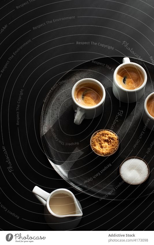 Cups of coffee served on a tray on dark background top aromatic specialty cups brew italian strong black coffee cups of expresso grain concept above mocha
