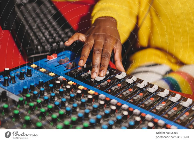 Crop black woman using control panel at radio station mix console broadcast host microphone on air radiocast female ethnic african american audio mixer live