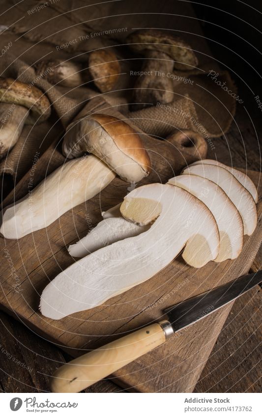 Sliced porcini mushrooms and knife on table boletus edulis cep slice cut fresh raw edible fungus organic food natural nutrition rustic ingredient vegan
