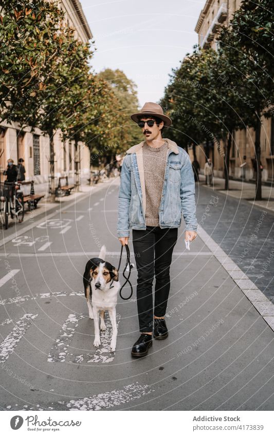 Man walking with dog in city man style treeing walker coonhound stroll together obedient companion male pet canine friend modern trendy animal urban enjoy