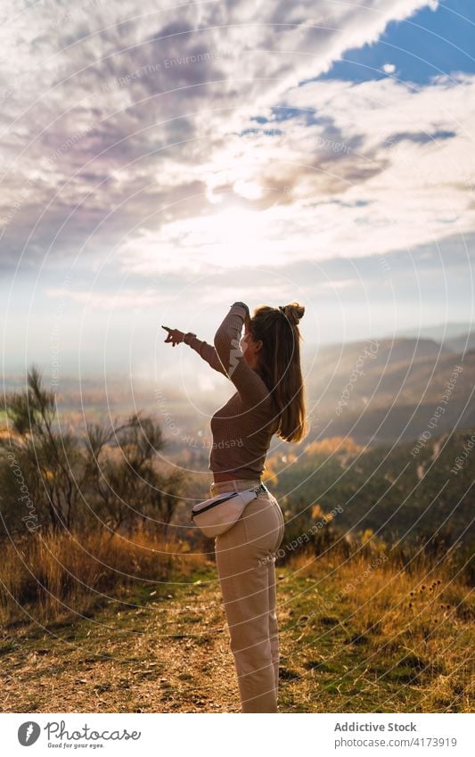 Woman enjoying freedom in autumn highlands woman mountain travel fresh valley nature hill young female pointing traveler hilltop journey wanderlust adventure
