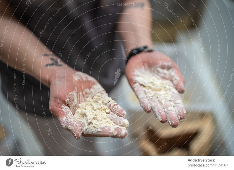 Crop baker with dough on hands bakery dirty messy flour bakehouse work kitchen prepare food pastry culinary chef fresh job raw cuisine recipe stand demonstrate