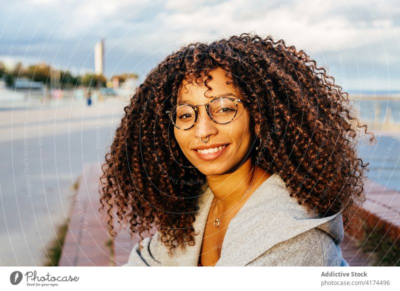 Cheerful black female standing on embankment woman sea smile style weekend happy outfit rest young quay cheerful ethnic african american water delight relax