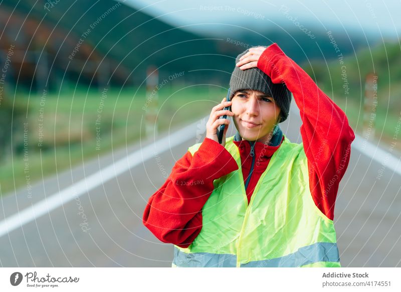 Worried woman in reflective vest talking on smartphone call insurance road worried help bewilder problem female driver mobile gadget device service trouble