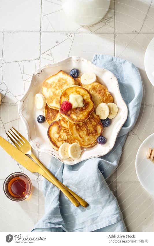 A stack of buttermilk pancakes breakfast food fluffy dessert delicious top view sirup meal sweet homemade white maple gold plate honey pile fresh morning baked