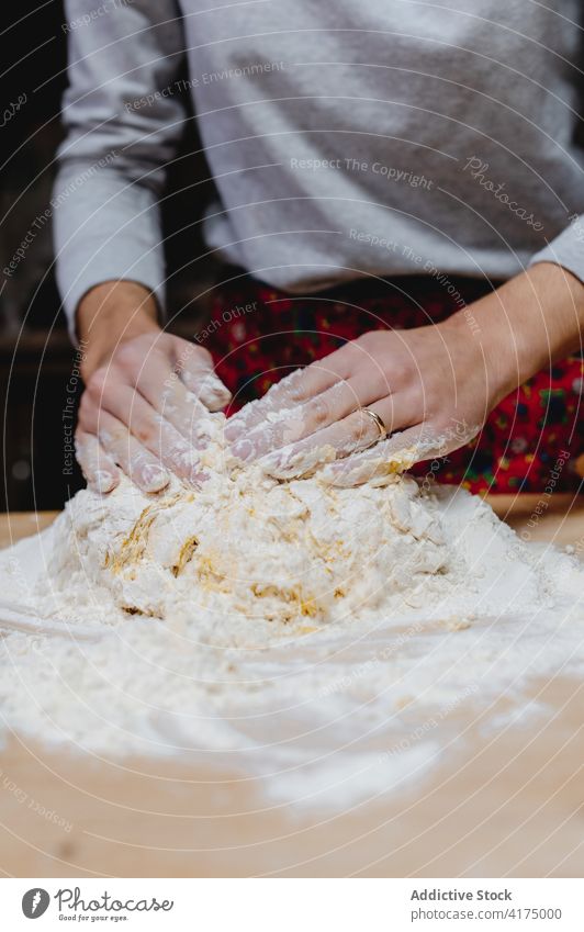 Young woman kneading dough at table in kitchen cook raw homemade food flour prepare pastry culinary female tortellini italian food italian cuisine domestic