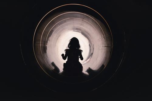 Child slides through a slide tube on the playground Dress Girl Slide Playground Tunnel trust courageous overcome Light at the end of the tunnel Pipeline conduit