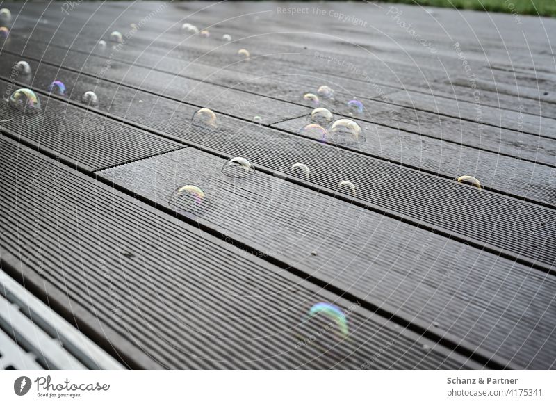 Soap bubbles on the terrace planks soap bubbles Playing Child children Infancy Terrace Balcony Garden Wooden boards Joy Happy burst dreams