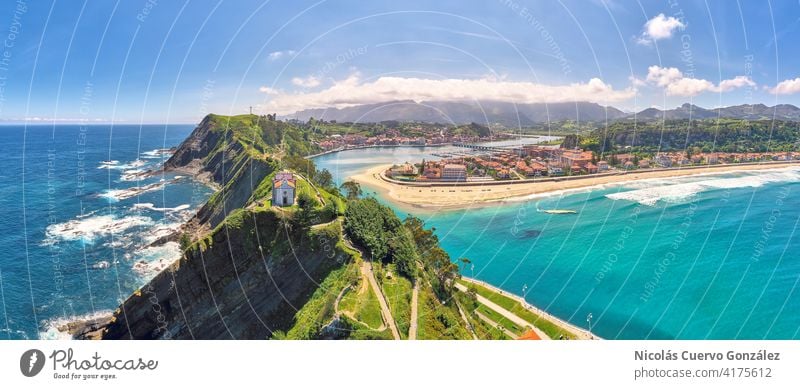 Aerial panoramic view of beach town secluded by dramatic mountains Panorama (View) Aerial photograph Beach cliff travel Mountain coast church Ocean Nature