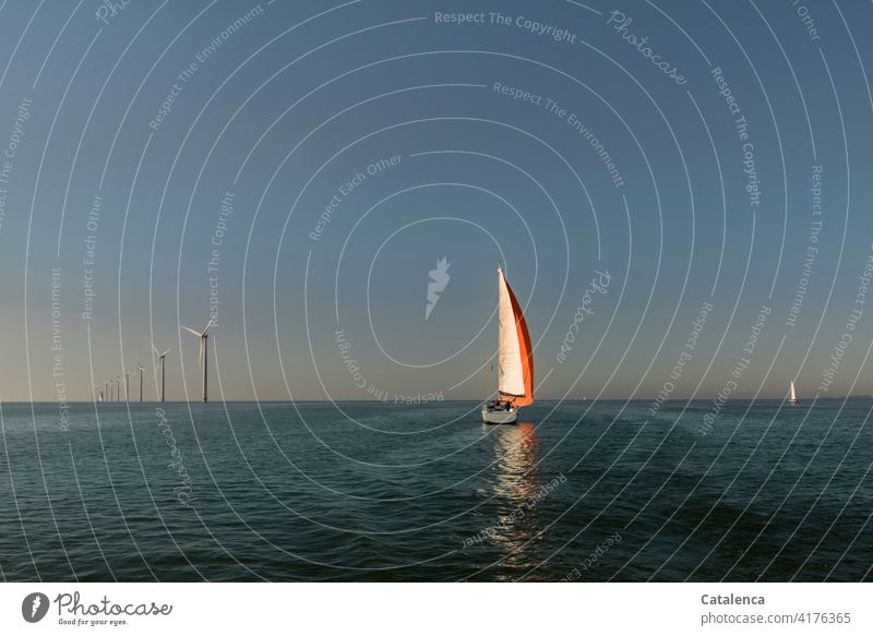 Set in motion by the wind Renewable energy Energy windmills Nature Water Waves windy Navigation Ocean sailing yacht Horizon Sky Vacation & Travel Sailing Summer