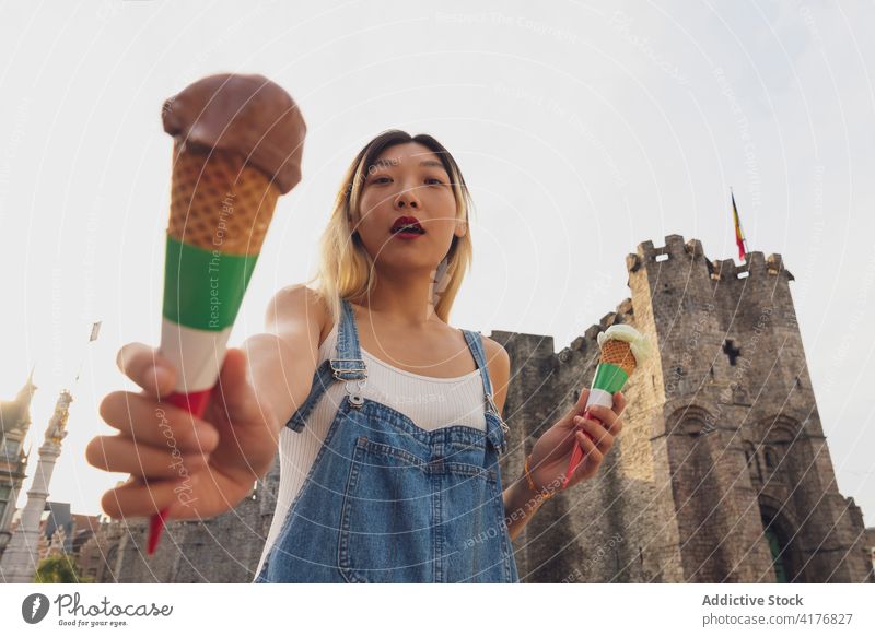 Ethnic woman with ice cream in cones on street summer scoop treat city stroll refreshment female ethnic asian sweet waffle enjoy tasty trendy dessert young