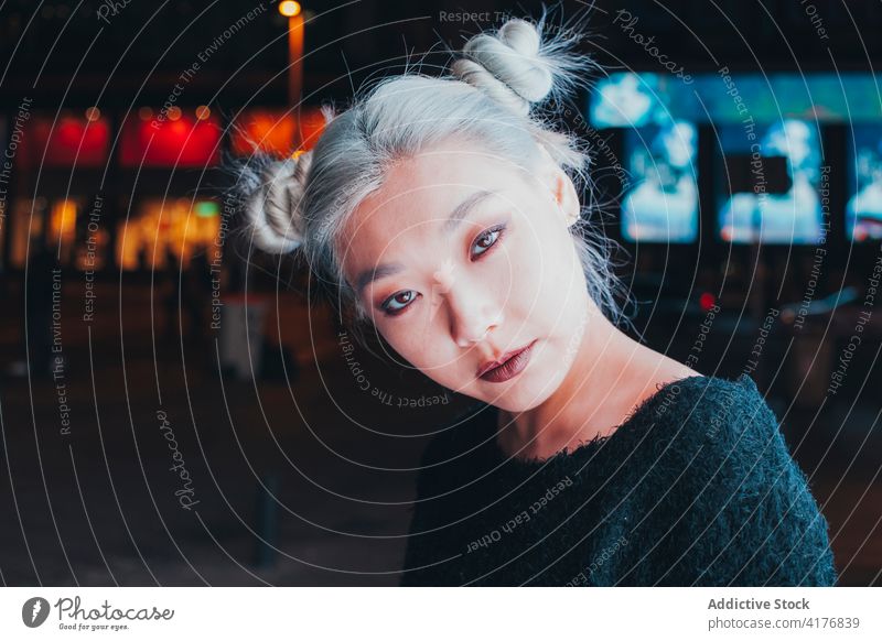 Ethnic young woman with dyed blonde hair informal alternative dyed hair style teen adolescent modern urban asian ethnic female makeup millennial trendy