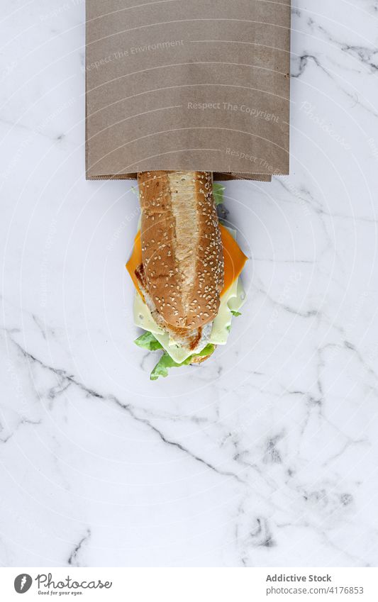 Delicious sandwich in paper bag on table takeaway food to go cheese tasty meal fresh yummy delicious vegetable lunch marble nutrition craft bread ingredient