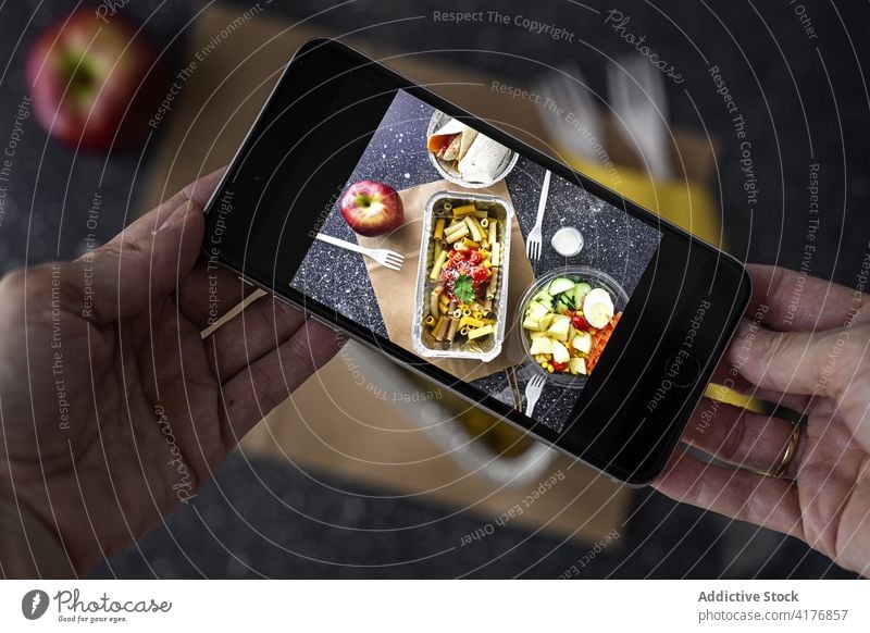 Crop person taking photo of takeaway food food photography take photo blogger smartphone to go lunch social media gadget device meal memory creative