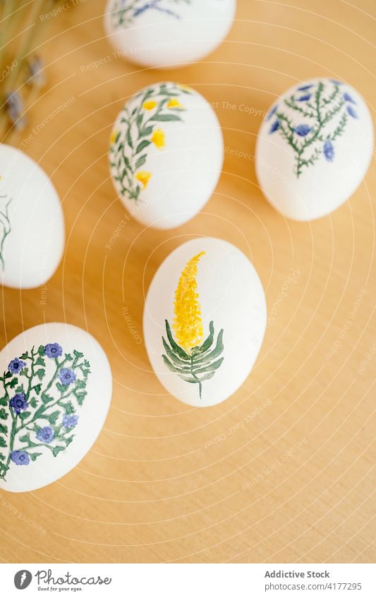 Various painted eggs arranged on table easter aquarelle flower holiday religious food tradition lavender candle spring religion decor color set collection