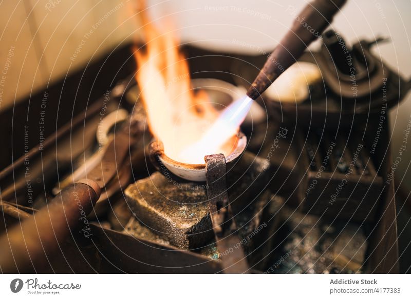 Process of melting metal in jewelry workshop burner flame professional tool process goldsmith manufacture production equipment craft manual artisan