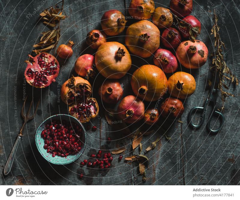 Ripe pomegranates on dark table fruit fresh natural delicious sweet color dried plant colorful pile composition heap nutrition season healthy food organic