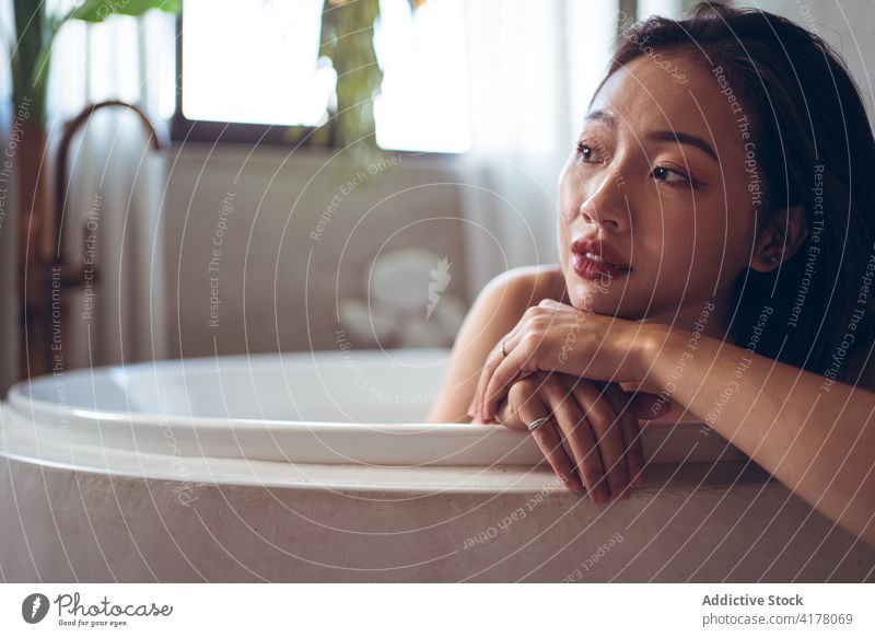 Ethnic woman resting in bathtub in oriental style room interior design tradition relax hotel young asian ethnic female travel tourism enjoy vacation chill