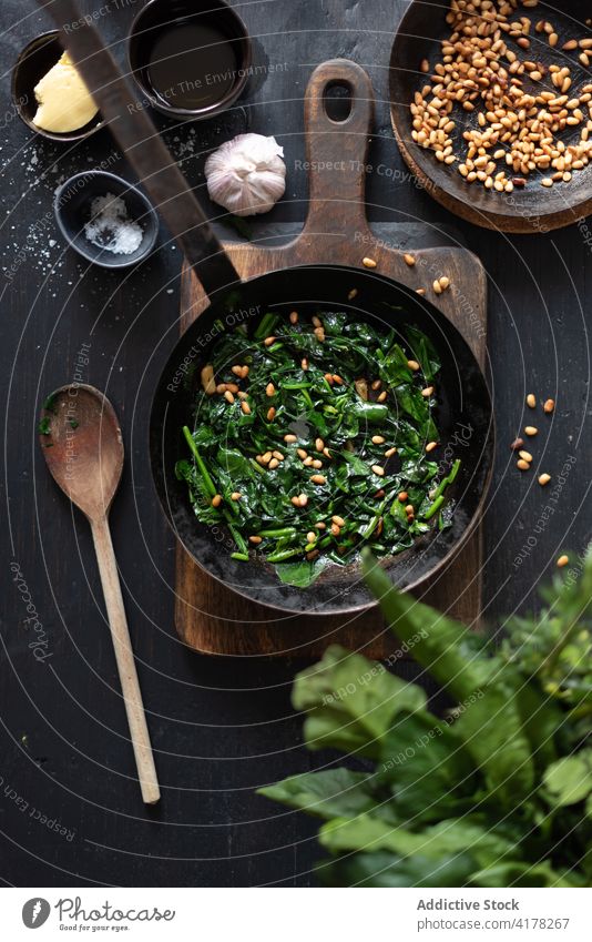 Delicious spinach with pine nuts in frying pan dish catalan delicious table kitchen serve tasty homemade culinary gourmet ingredient fresh appetizing nutrition