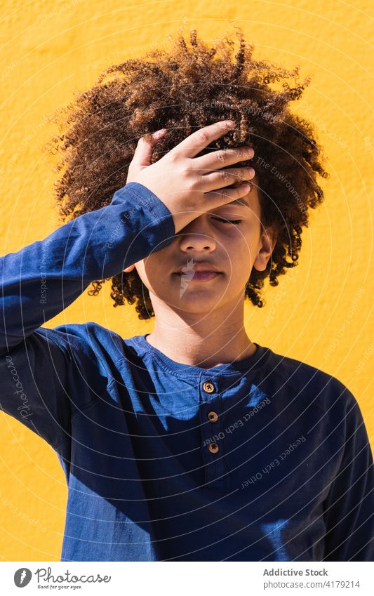 African American boy slapping forehead disappoint forget mistake think curly hair kid confuse problem afro black ethnic african american male touch head teen