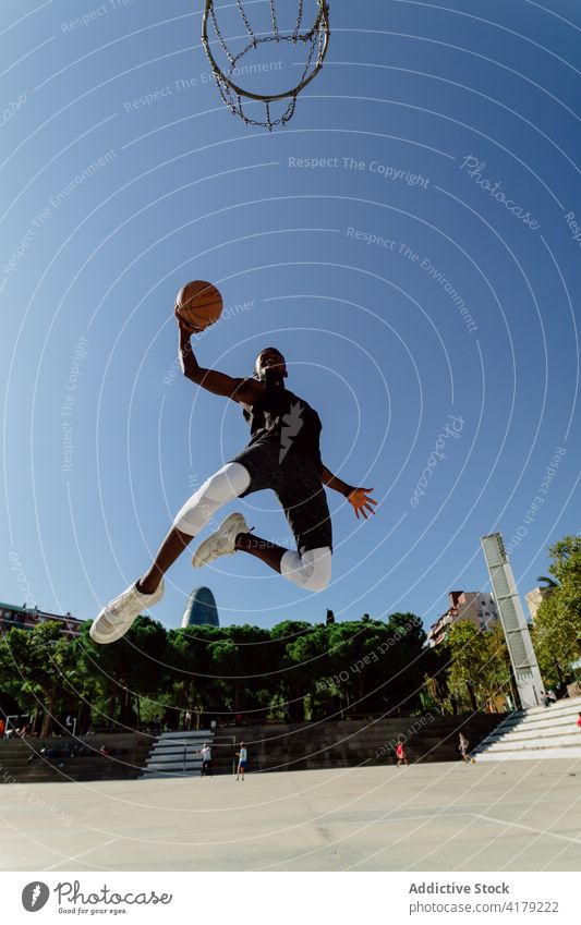 African American sportsman playing basketball on court player jump hoop sports ground score male ethnic black african american moment activity training energy