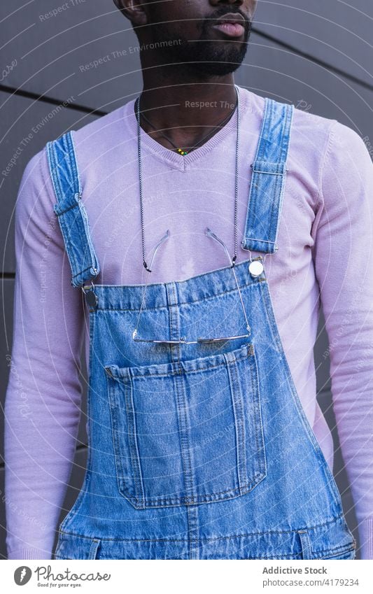 Crop stylish black man in overalls style trendy city cool urban jeans denim street male ethnic african american sweatshirt modern stand contemporary town summer