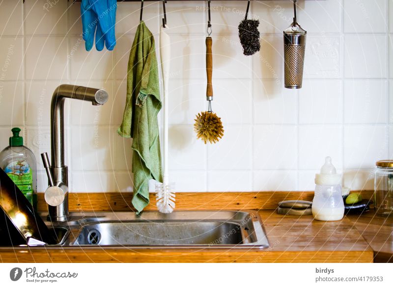 Everyday sight of a kitchen sink in a family household. Kitchen Sink Tap utensils kitchen utensils Dishwashing utensils tiled Wooden worktop Baby's bottle