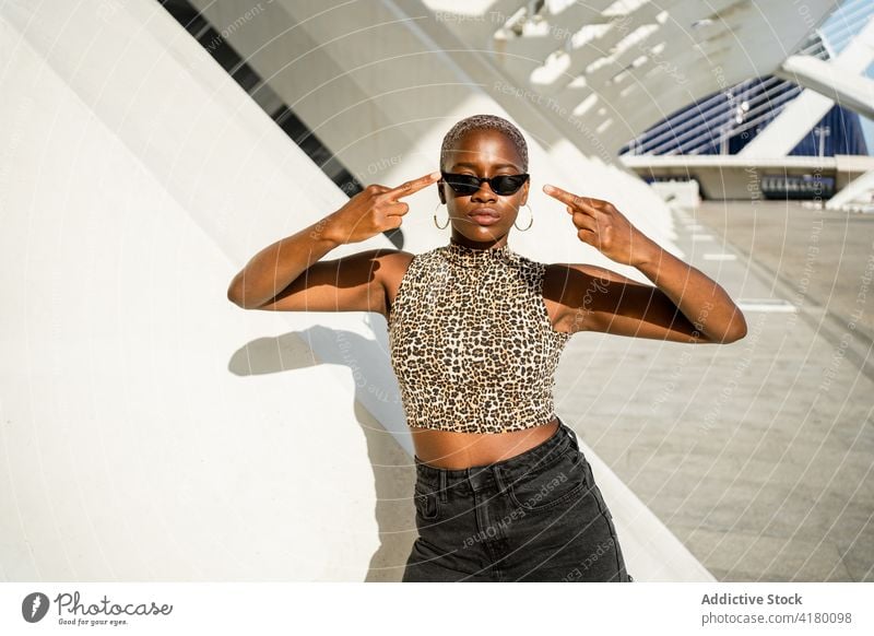 Happy black woman showing middle fingers on street fuck short hair gesture rude sign symbol rebel female ethnic african american cool sunglasses style urban