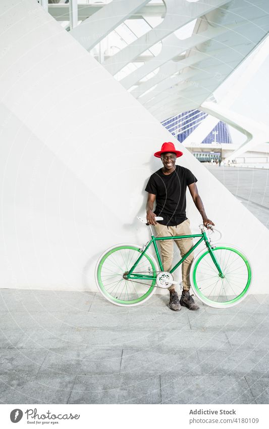 Stylish black man with bicycle in city urban style young bike modern trendy confident male ethnic african american street appearance hipster serious hat cool