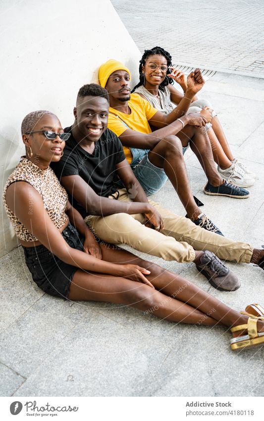 Company of young black people on street chill friend company together cool urban unity trendy ethnic african american building city gather weekend sit