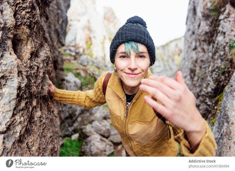 Content woman in rocky highlands portrait formation nature positive content asturias season rough stone spain glad optimist female young hat pretty friendly
