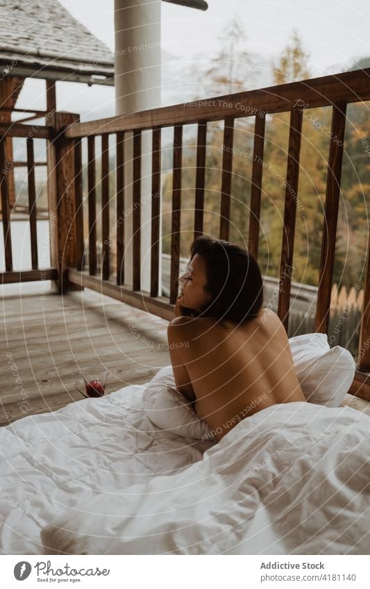 Topless woman lying on blanket on porch serene relax cottage countryside dreamy topless autumn season tranquil comfort peaceful soft charming tender sensitive