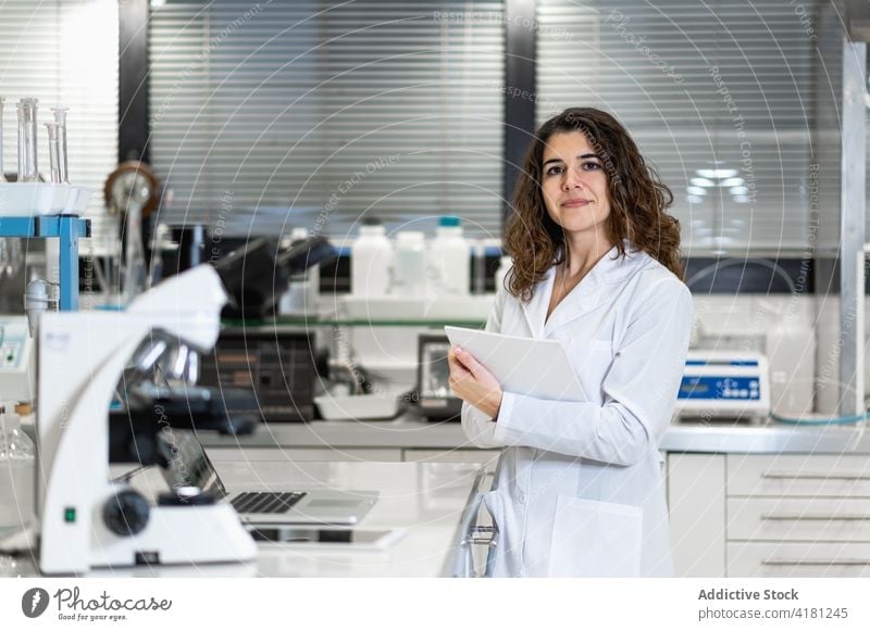 Woman in white coat working in laboratory scientist woman research pharmaceutical medical chemist professional female scientific job occupation workplace