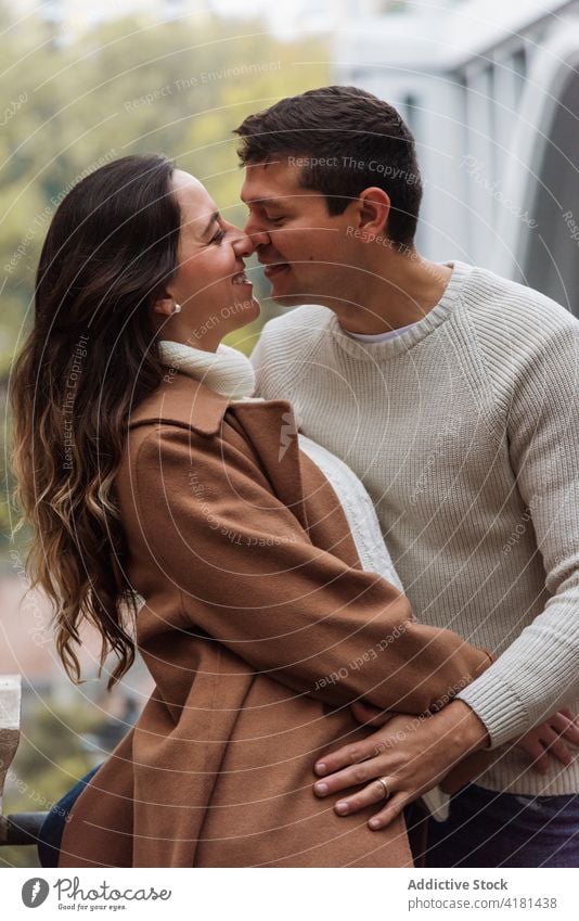 Loving couple in outerwear embracing on street hug embrace romantic warm clothes cheerful love amorous fondness autumn relationship soulmate affection happy