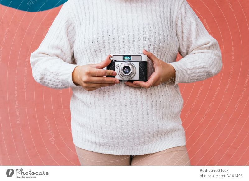 Unrecognizable photographer taking photo on camera near wall outdoors take photo photo camera digital focus lens memory woman moment using device attentive