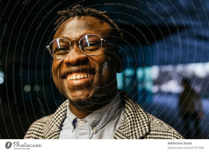 Happy black manager in eyeglasses in night city employee office formal happy style town portrait eyewear smile accessory thoughtful ponder wistful modern ethnic