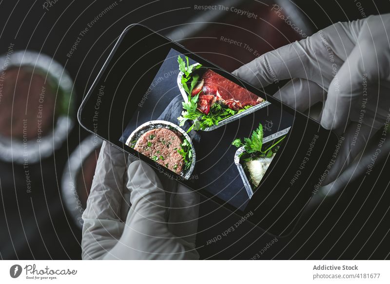 Crop person taking photo of raw meat on smartphone cook take photo takeaway convenient food photography container package service single use disposable