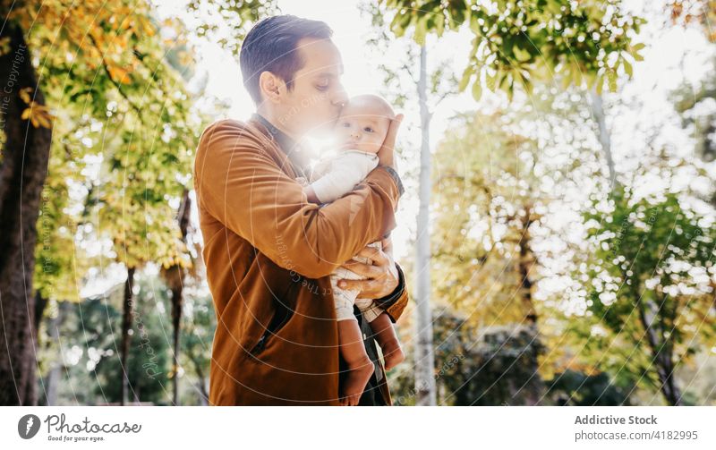 Father with baby resting in park dad love together infant child kid father relationship bonding parenthood adorable childhood babyhood fondness enjoy fatherhood