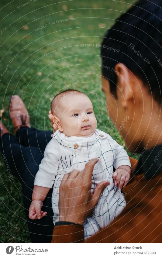 Father with baby resting in park dad love together infant child kid father relationship bonding parenthood adorable childhood babyhood fondness enjoy fatherhood
