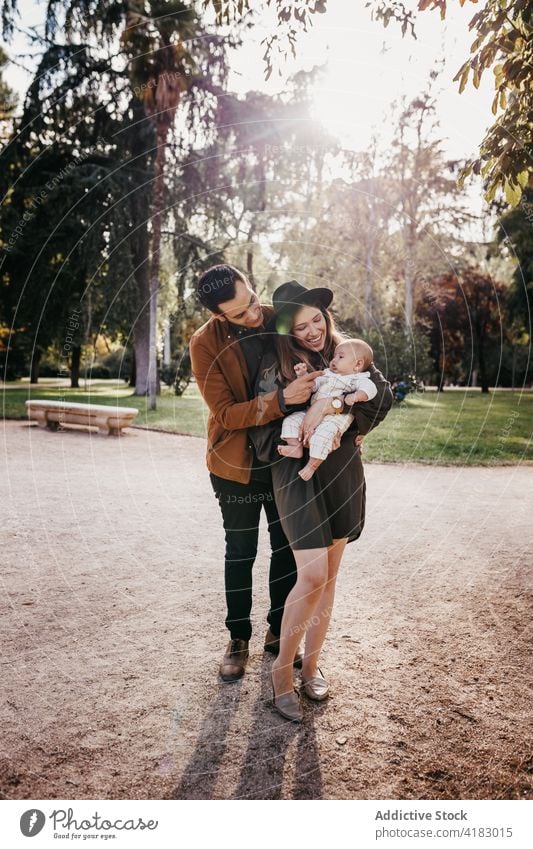 Happy family with baby resting in park together love happy parent relationship bonding care infant child mother father kid parenthood childhood mom enjoy
