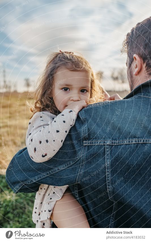 Father hugging little girl in field father daughter tender child love countryside cute cuddle childhood bonding together embrace relationship kid parenthood