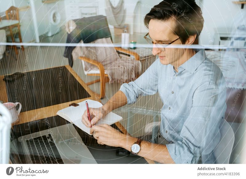 Businessman taking notes in notepad businessman take note notebook plan organizer write memo entrepreneur project male table pen professional planner work